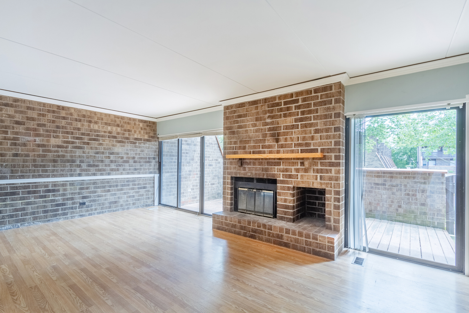 1010 Kenneth Circle Elgin, IL 60120 - Photo 4 of 18 a view of an empty room with wooden floor and a fireplace