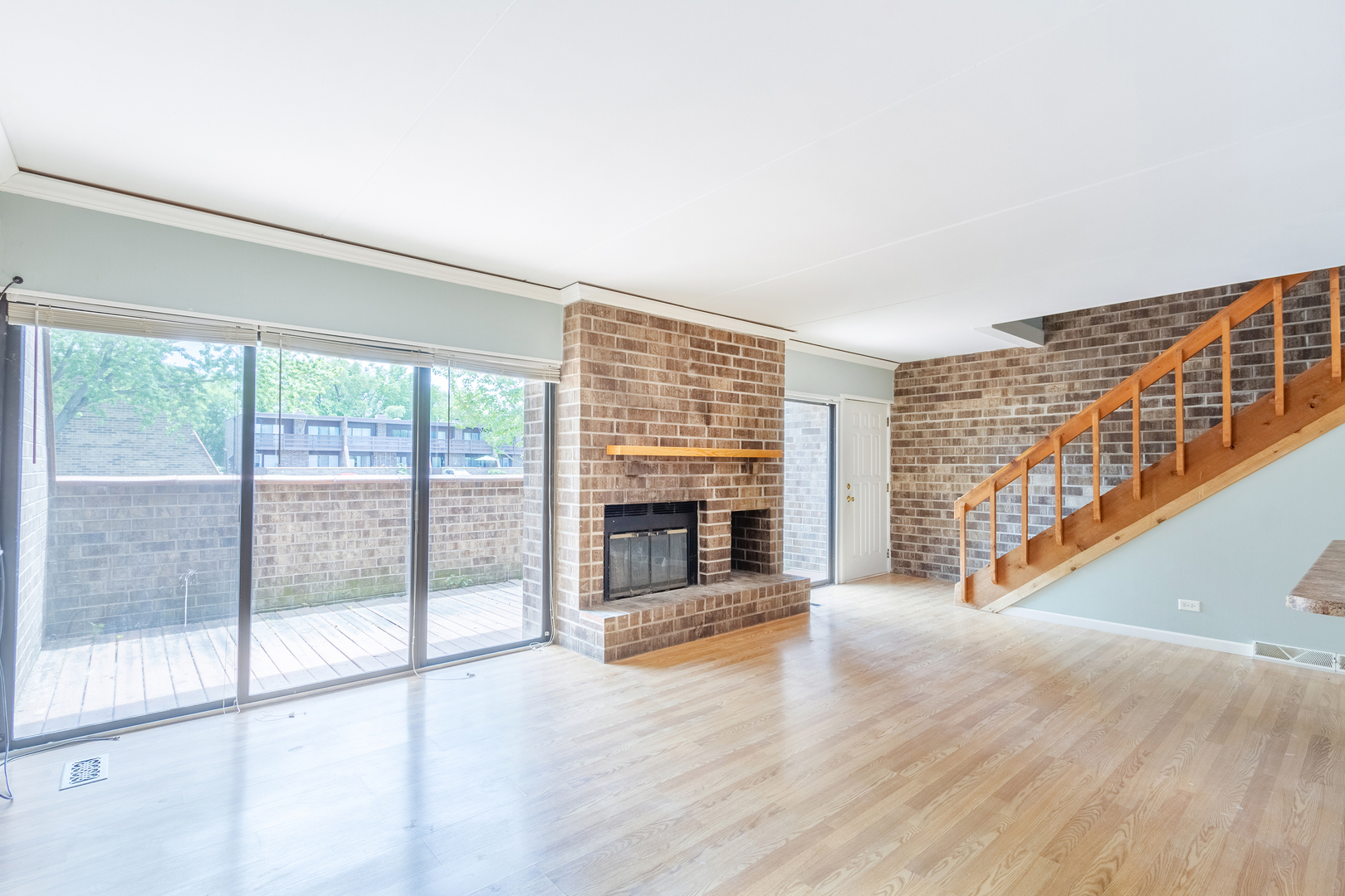 1010 Kenneth Circle Elgin, IL 60120 - Photo 5 of 18 a view of an empty room with wooden floor and a fireplace