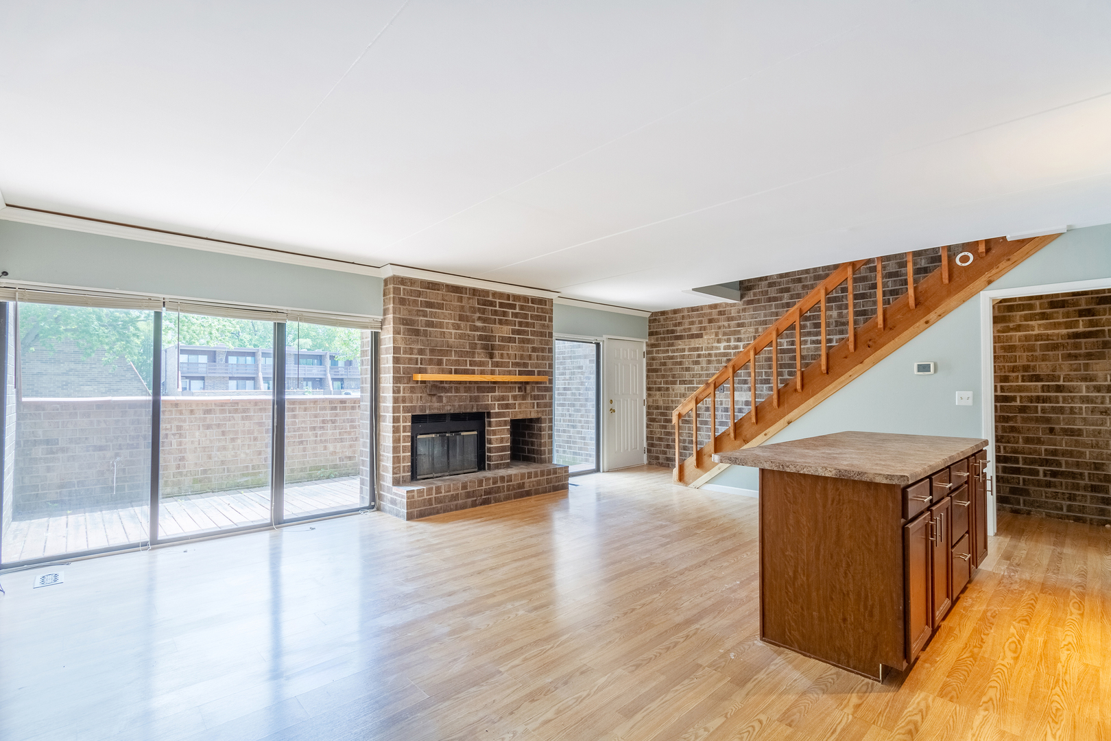 1010 Kenneth Circle Elgin, IL 60120 - Photo 6 of 18 a view of an empty room with wooden floor and a window