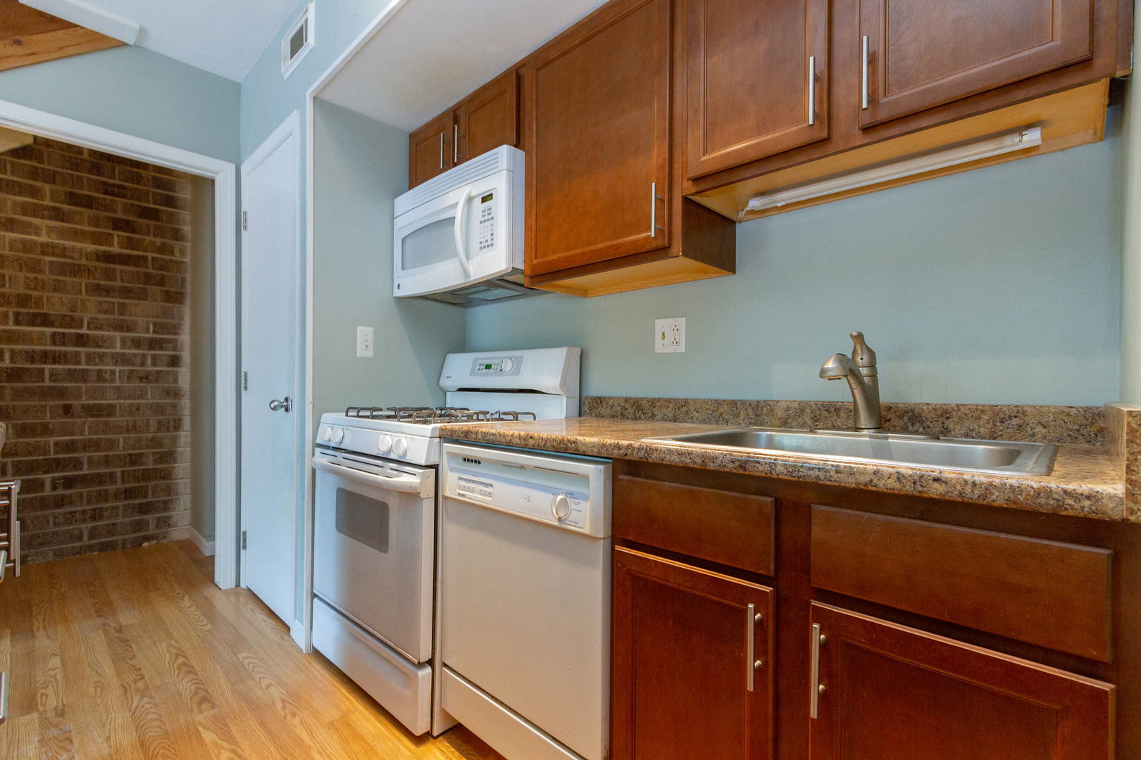1010 Kenneth Circle Elgin, IL 60120 - Photo 7 of 18 a kitchen with stainless steel appliances granite countertop a sink and cabinets