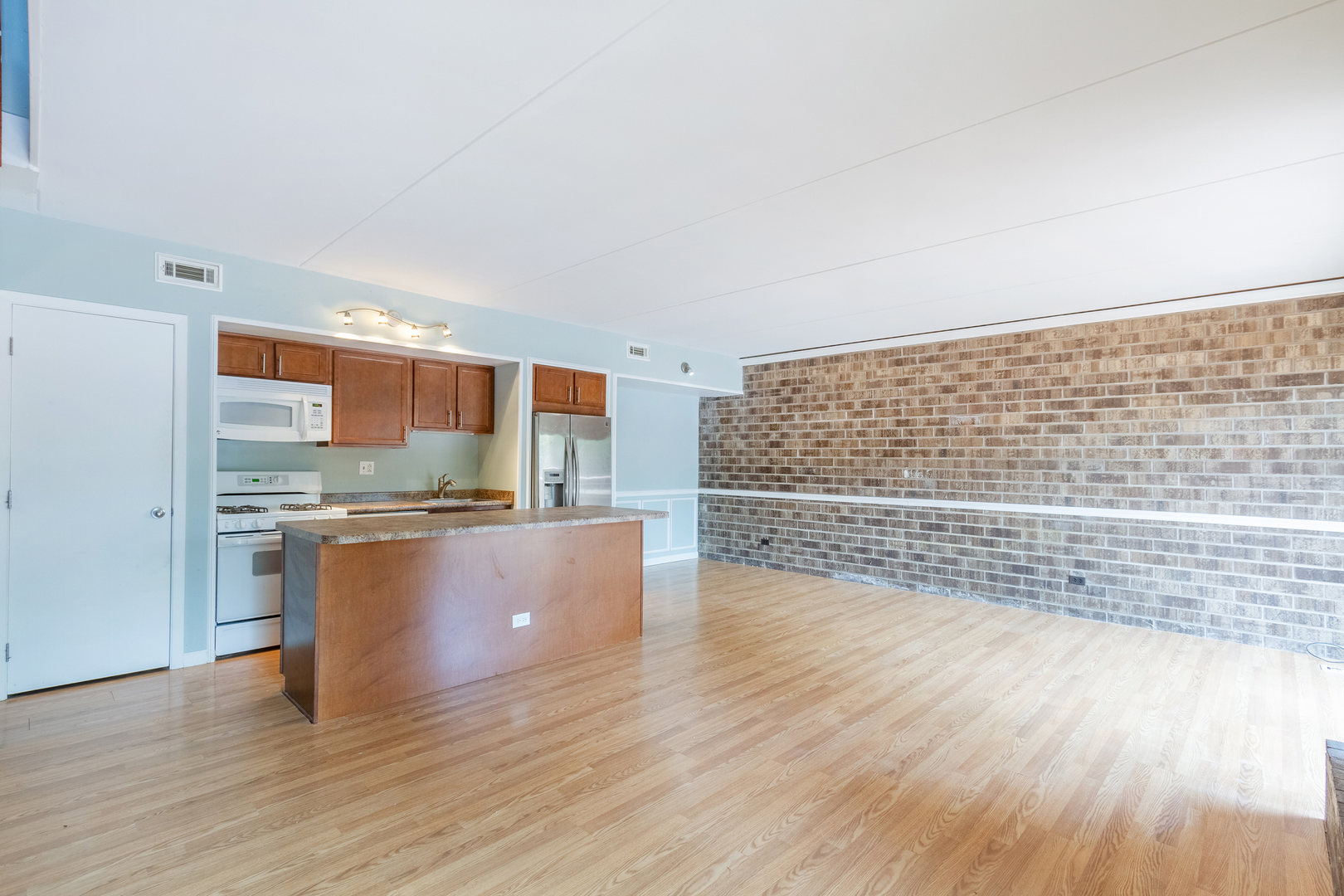 1010 Kenneth Circle Elgin, IL 60120 - Photo 8 of 18 a view of kitchen with kitchen island wooden floor and stainless steel appliances