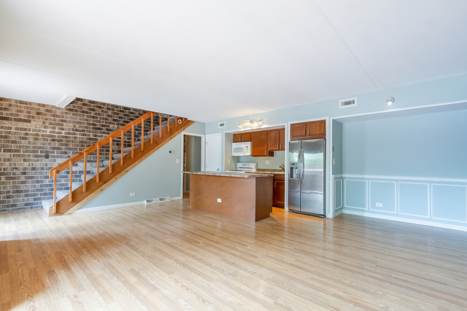 1010 Kenneth Circle Elgin, IL 60120 - Photo 9 of 18 a view of a room with wooden floor and stairs