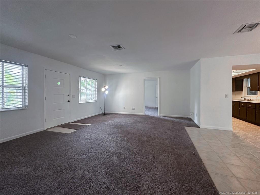 1739 Southeast Madison Street Stuart, FL 34997 - Photo 12 of 38 an empty room with windows and fireplace