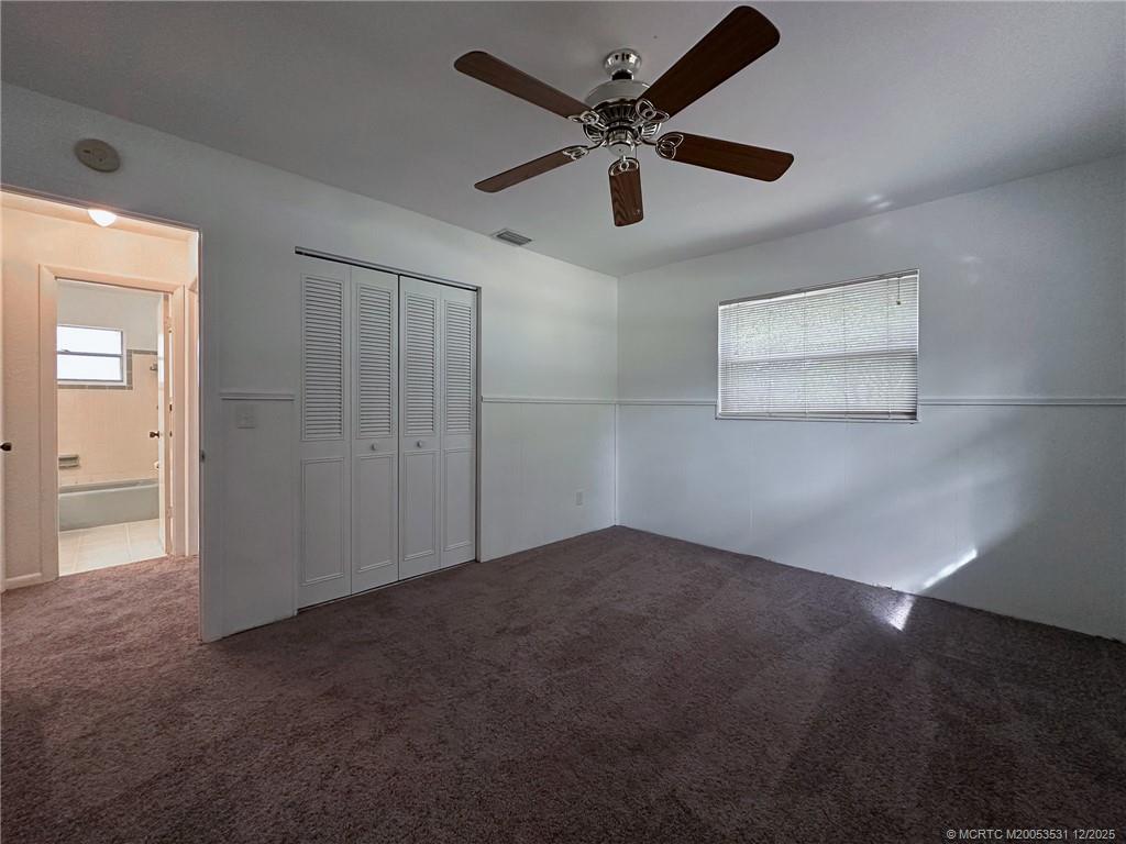 1739 Southeast Madison Street Stuart, FL 34997 - Photo 15 of 38 an empty room with a ceiling fan and windows