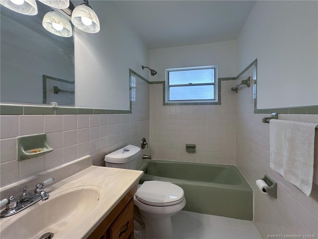 1739 Southeast Madison Street Stuart, FL 34997 - Photo 19 of 38 a bathroom with a sink a toilet and shower