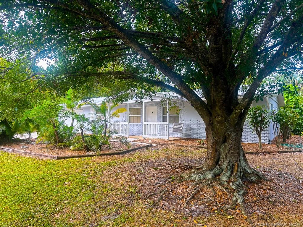 1739 Southeast Madison Street Stuart, FL 34997 - Photo 2 of 38 a view of a backyard with large tree