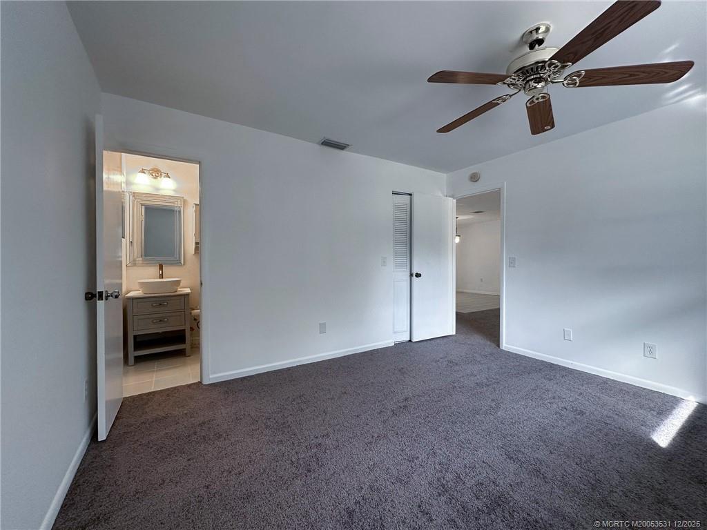 1739 Southeast Madison Street Stuart, FL 34997 - Photo 21 of 38 a view of empty room with a ceiling fan