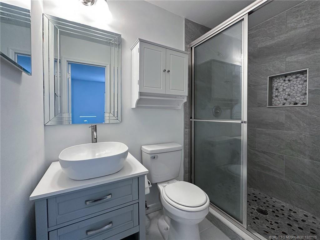 1739 Southeast Madison Street Stuart, FL 34997 - Photo 22 of 38 a bathroom with a sink toilet and shower