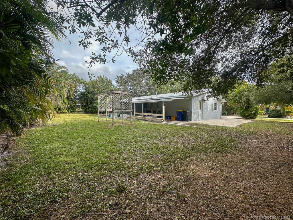 1739 Southeast Madison Street Stuart, FL 34997 - Photo 36 of 38 a front view of house with yard and green space