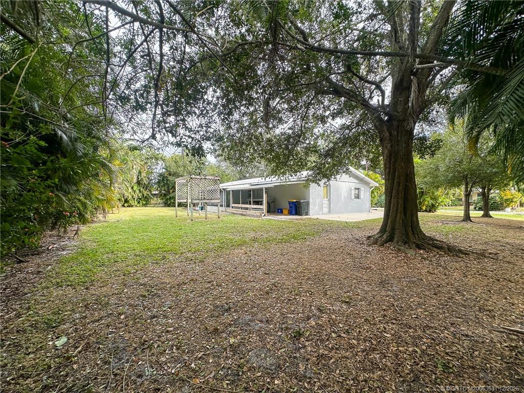 1739 Southeast Madison Street Stuart, FL 34997 - Photo 37 of 38 a front view of a house with a yard