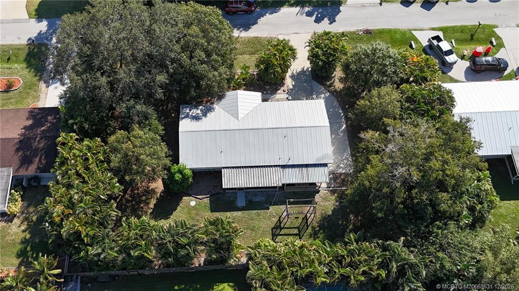 1739 Southeast Madison Street Stuart, FL 34997 - Photo 7 of 38 an aerial view of a house with a yard and potted plants