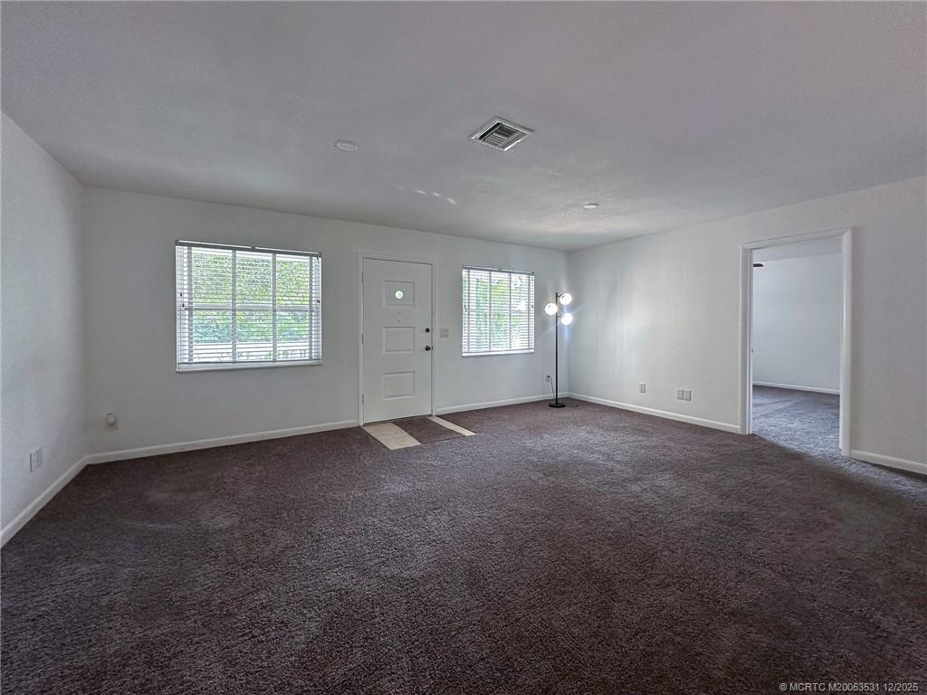 1739 Southeast Madison Street Stuart, FL 34997 - Photo 9 of 38 an empty room with windows and closet