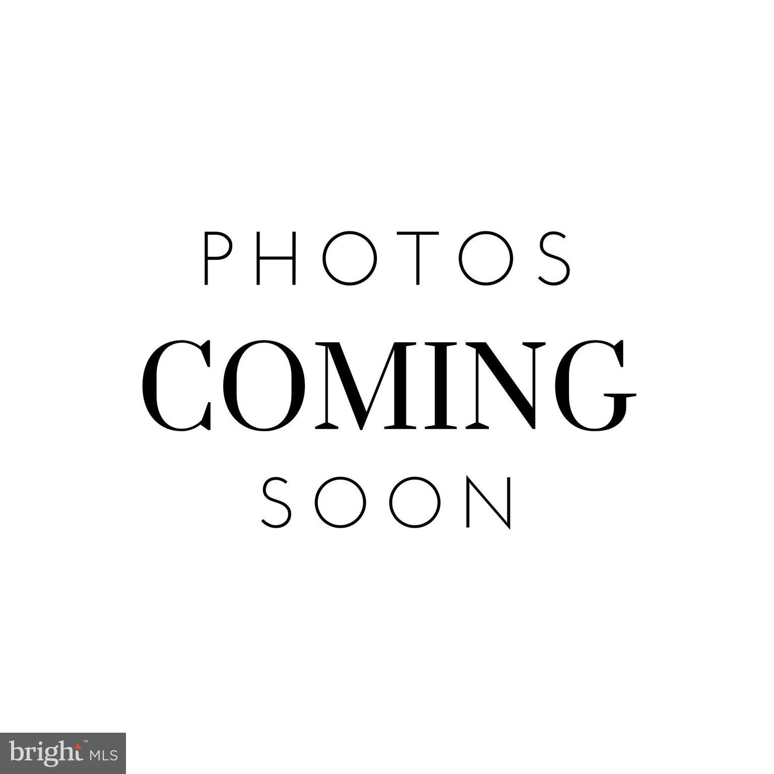 a view of a kitchen with a sink and a white wall