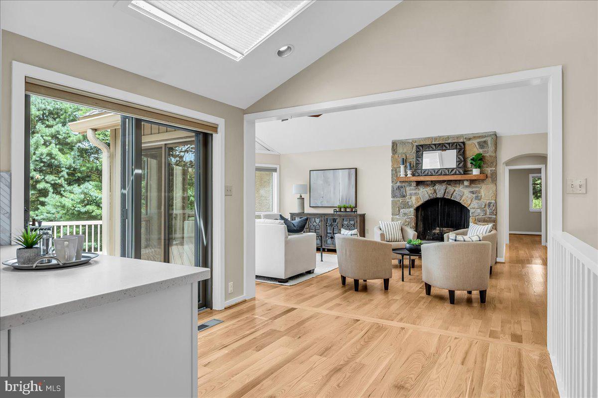 977 Wind Song Road West Chester, PA 19382 - Photo 14 of 57 a living room with furniture a fireplace and a floor to ceiling window