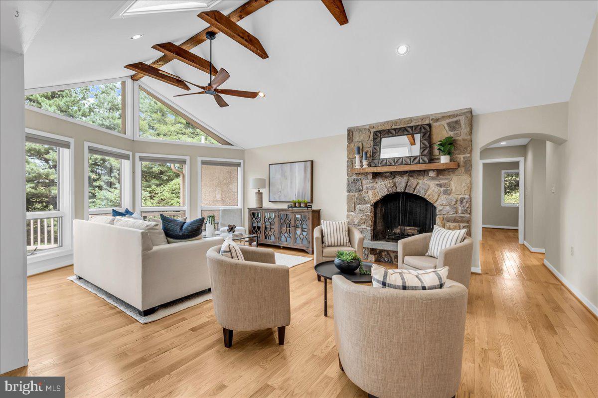 977 Wind Song Road West Chester, PA 19382 - Photo 18 of 57 a living room with furniture a fireplace and a floor to ceiling window