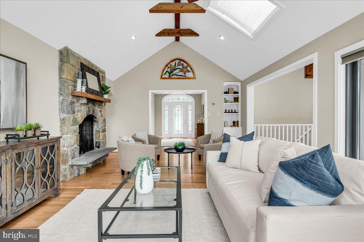 977 Wind Song Road West Chester, PA 19382 - Photo 19 of 57 a living room with fireplace furniture and a window