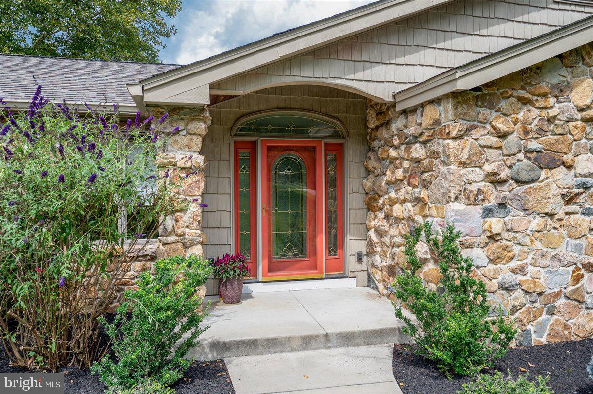977 Wind Song Road West Chester, PA 19382 - Photo 2 of 57 a front view of a house with a garage