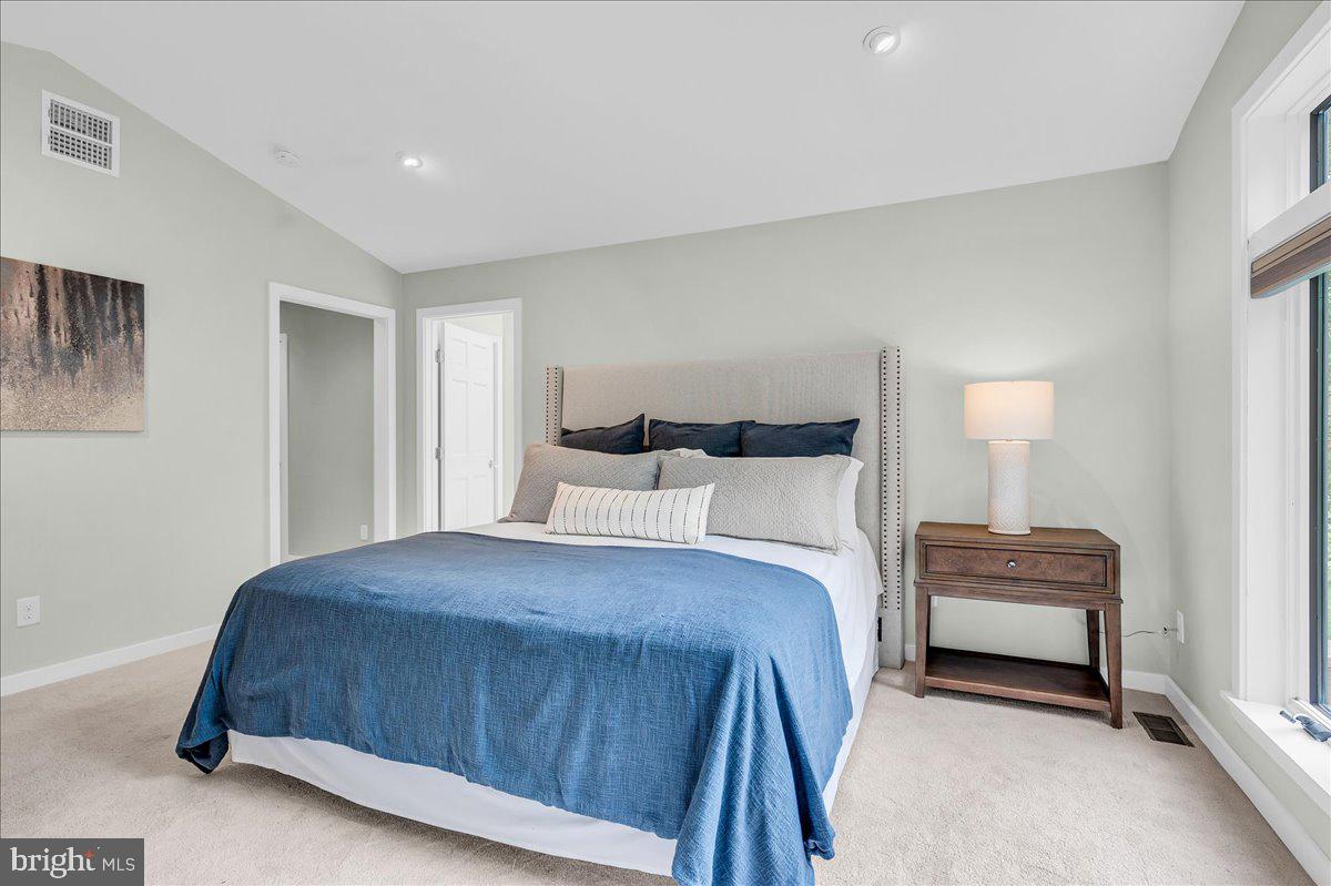 977 Wind Song Road West Chester, PA 19382 - Photo 26 of 57 a bedroom with a bed and a couch