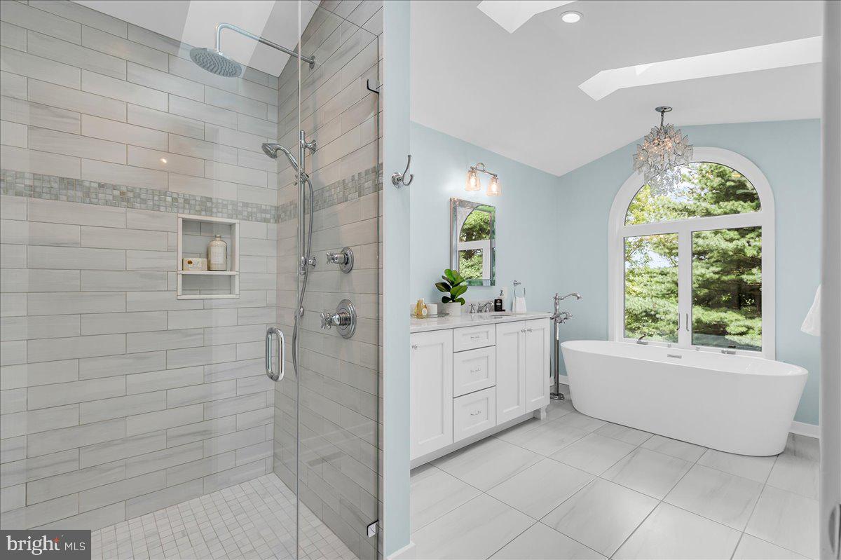 977 Wind Song Road West Chester, PA 19382 - Photo 29 of 57 a bathroom with a bathtub a sink and a window