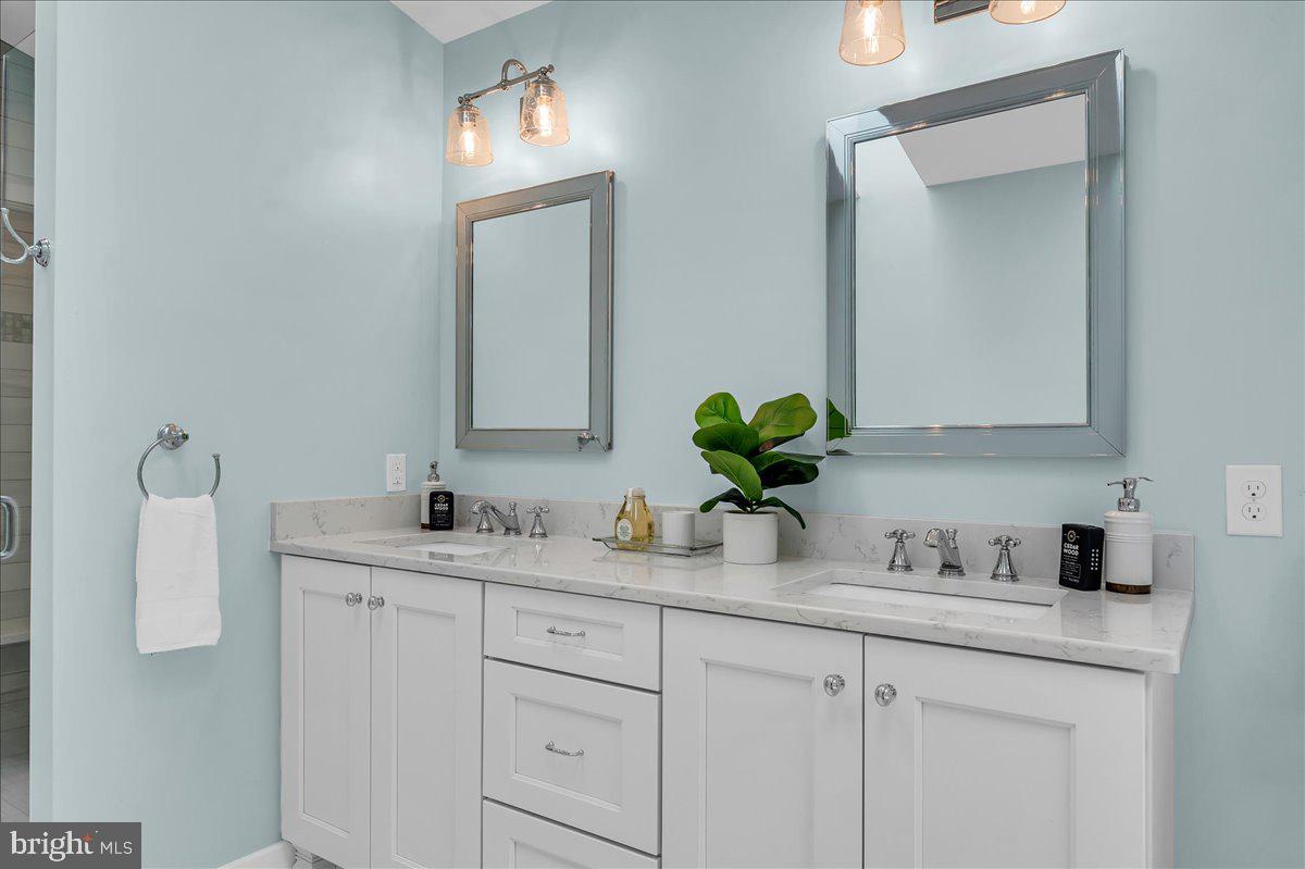 977 Wind Song Road West Chester, PA 19382 - Photo 30 of 57 a bathroom with cabinets sink and mirror