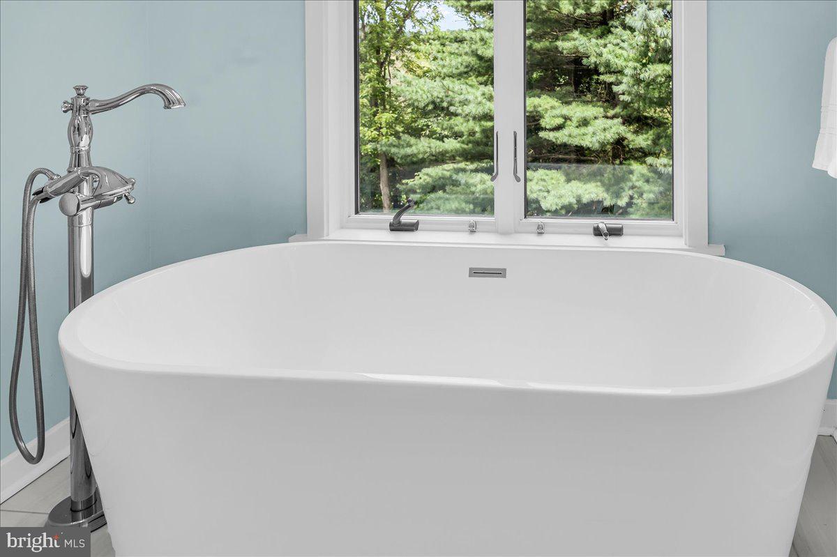 977 Wind Song Road West Chester, PA 19382 - Photo 31 of 57 a white bath tub sitting in a bathroom