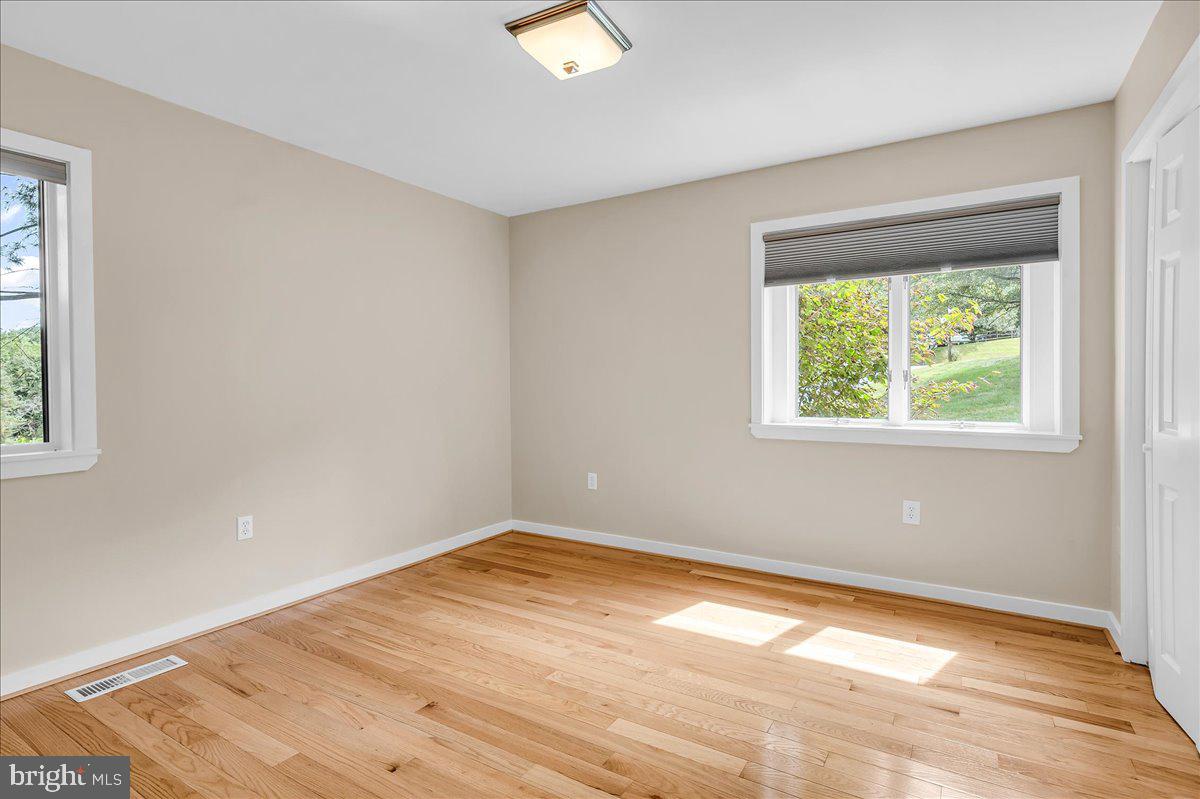 977 Wind Song Road West Chester, PA 19382 - Photo 33 of 57 a view of empty room with wooden floor and fan