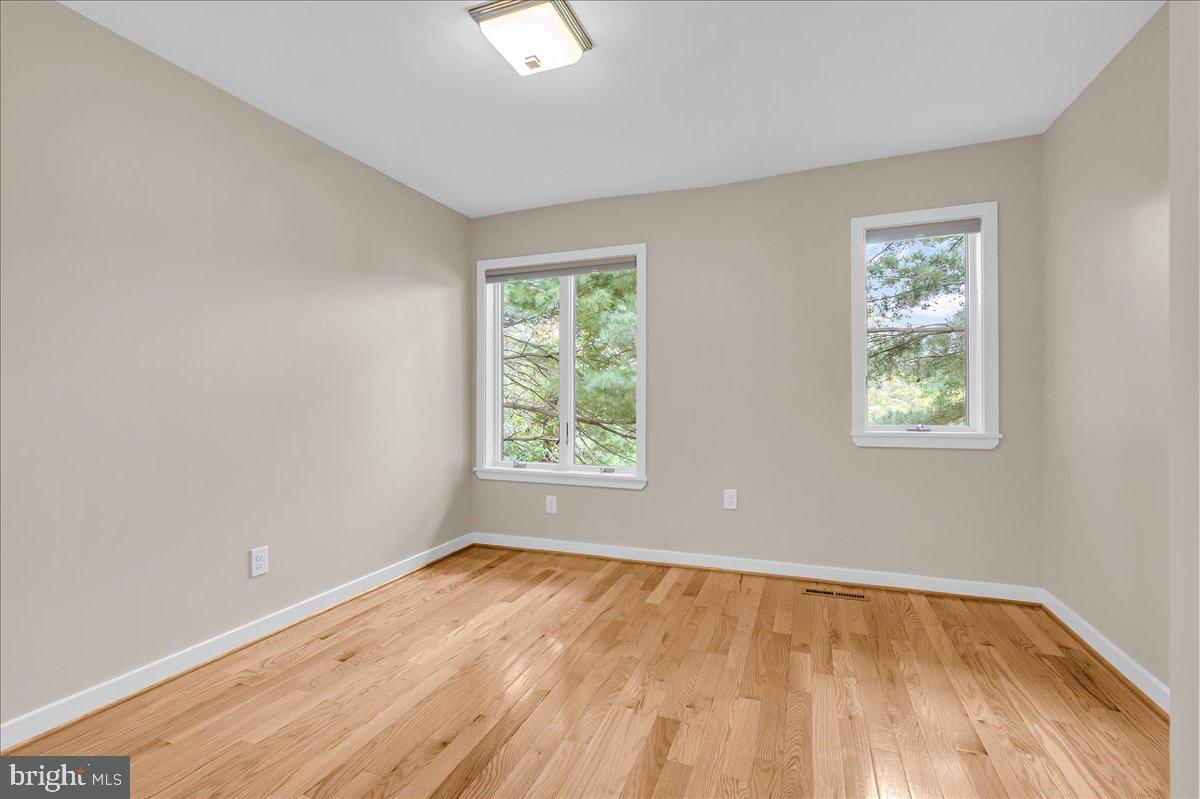 977 Wind Song Road West Chester, PA 19382 - Photo 34 of 57 a view of an empty room with wooden floor and a window