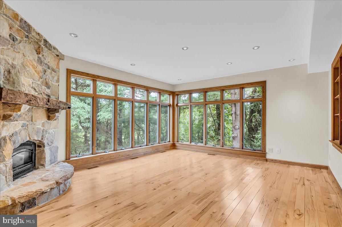977 Wind Song Road West Chester, PA 19382 - Photo 43 of 57 a view of an empty room with a window and wooden floor