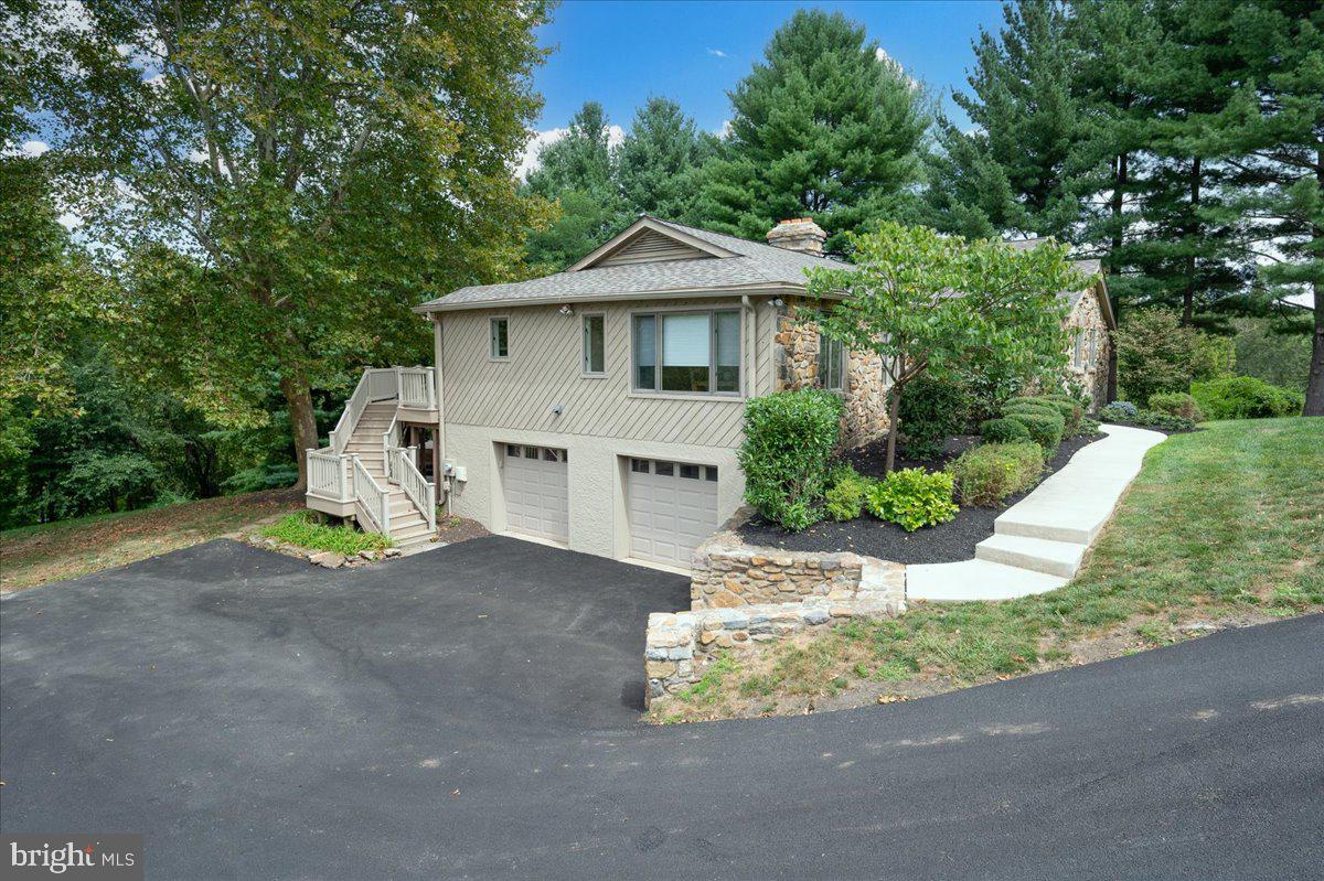 977 Wind Song Road West Chester, PA 19382 - Photo 48 of 57 a front view of a house with a yard and garage