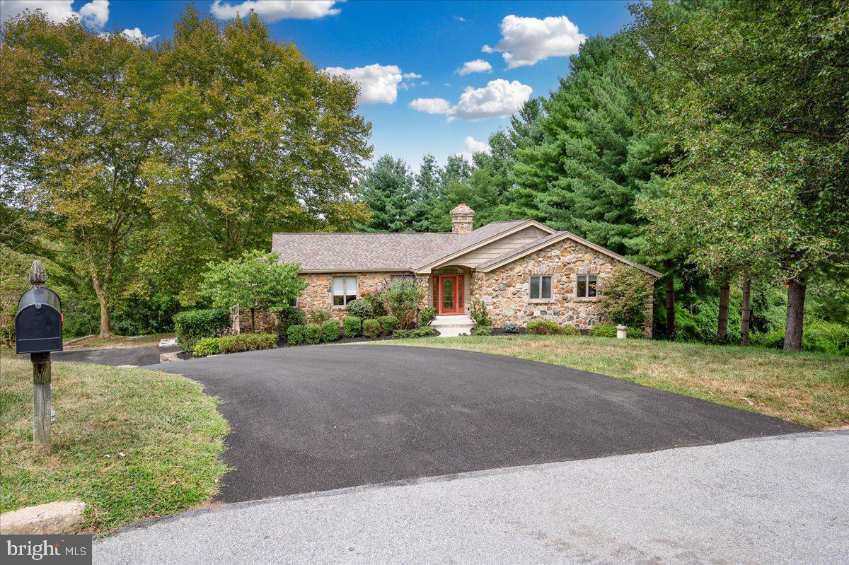 977 Wind Song Road West Chester, PA 19382 - Photo 49 of 57 a front view of a house with a yard and a garden