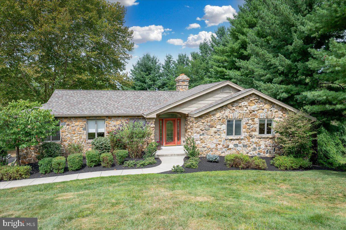 977 Wind Song Road West Chester, PA 19382 - Photo 50 of 57 a front view of a house with a garden and plants