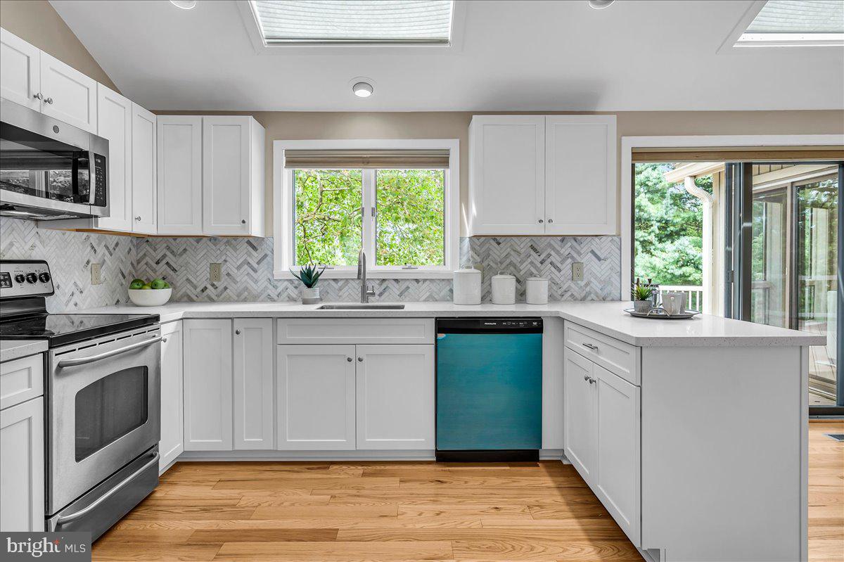 977 Wind Song Road West Chester, PA 19382 - Photo 10 of 57 a kitchen with stainless steel appliances white cabinets and window