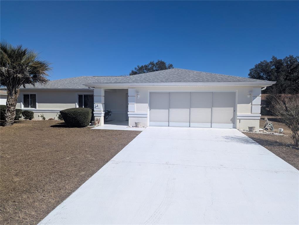 9871 Southwest 61st Terrace Ocala, FL 34476 - Photo 1 of 1 a view of a house with a yard and plants