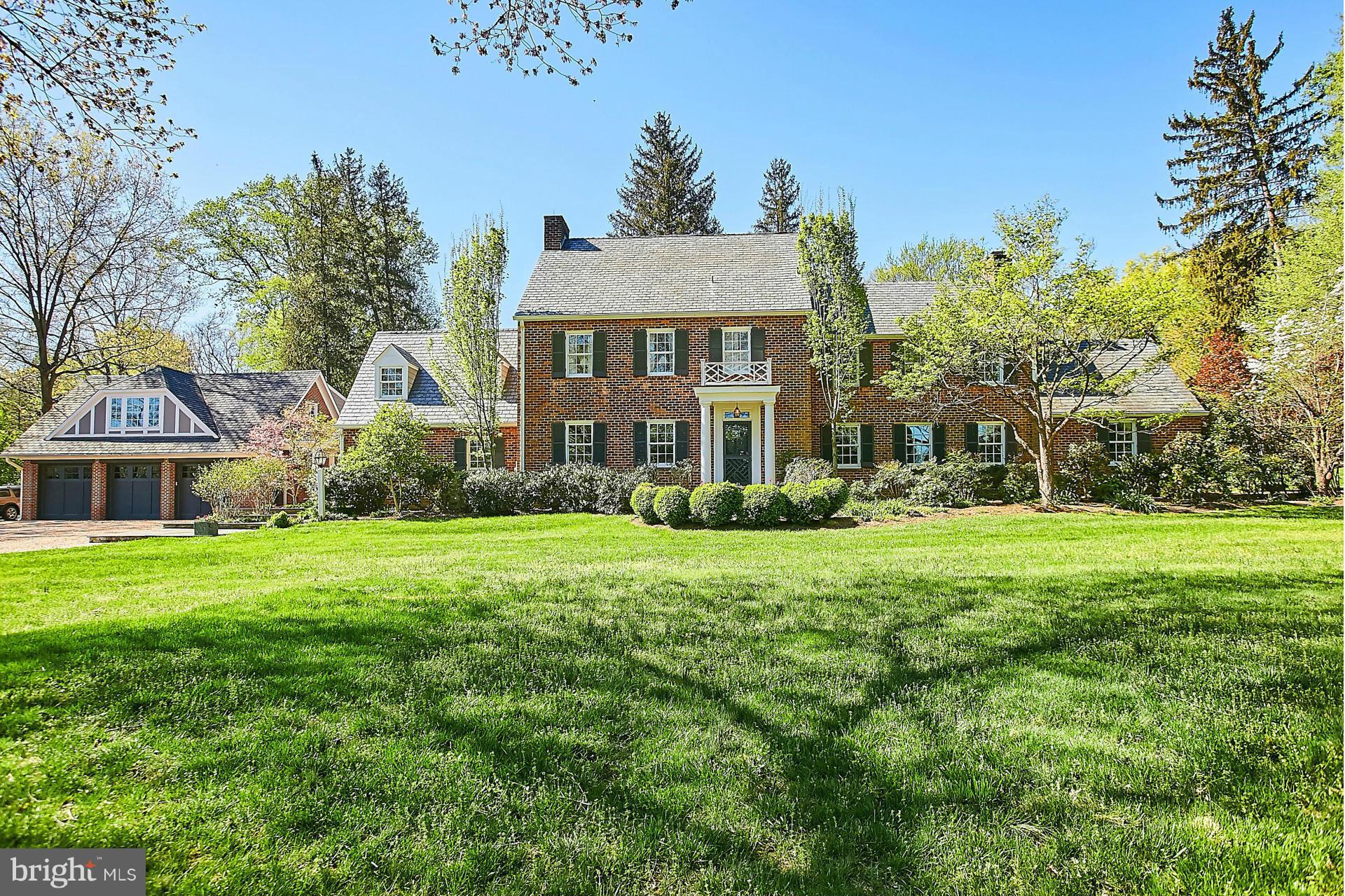 6539 Georgetown Pike McLean, VA 22101 - Photo 2 of 30 a front view of a house with a garden