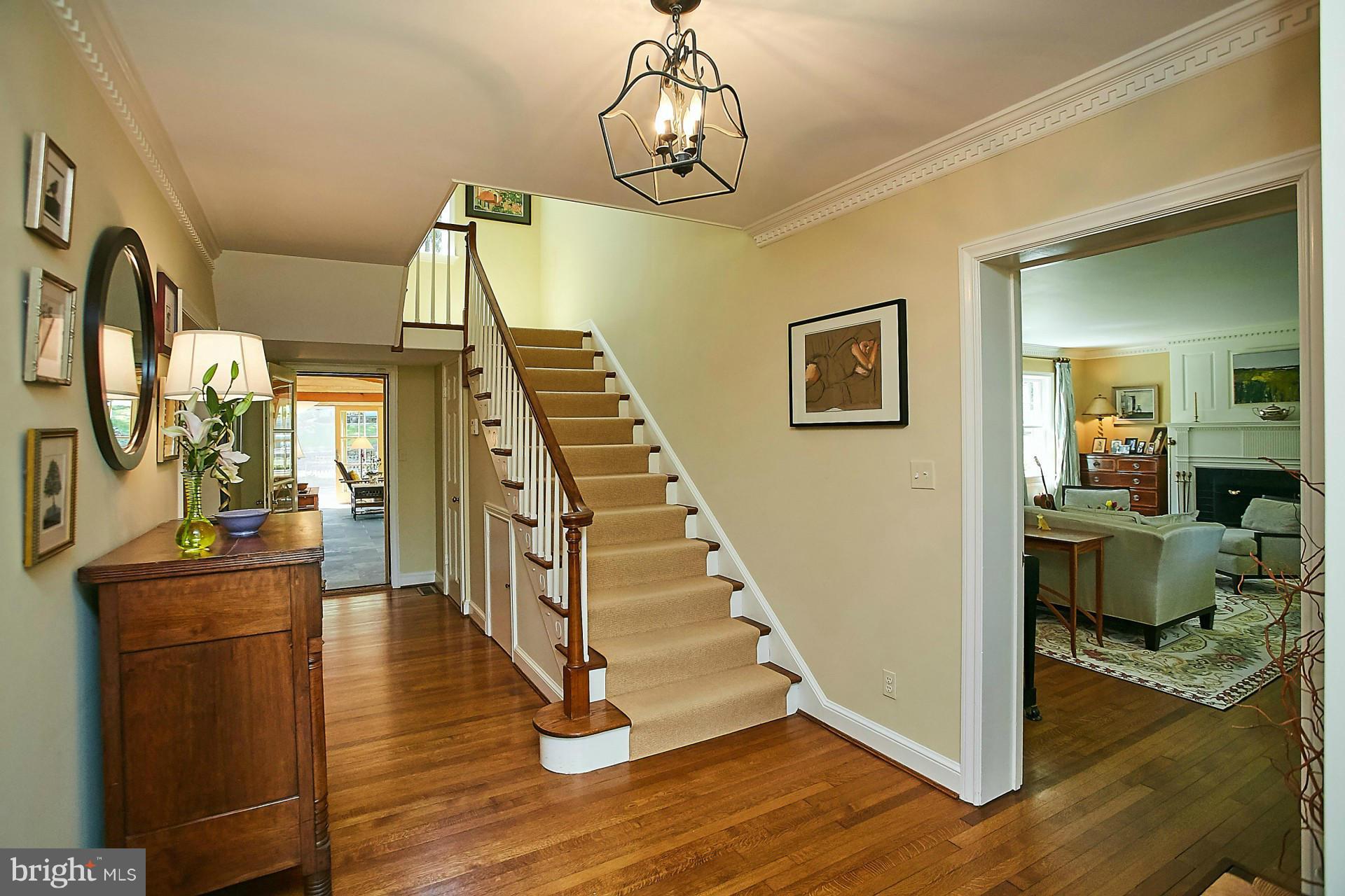 6539 Georgetown Pike McLean, VA 22101 - Photo 7 of 30 a view of a hallway with wooden floor and staircase