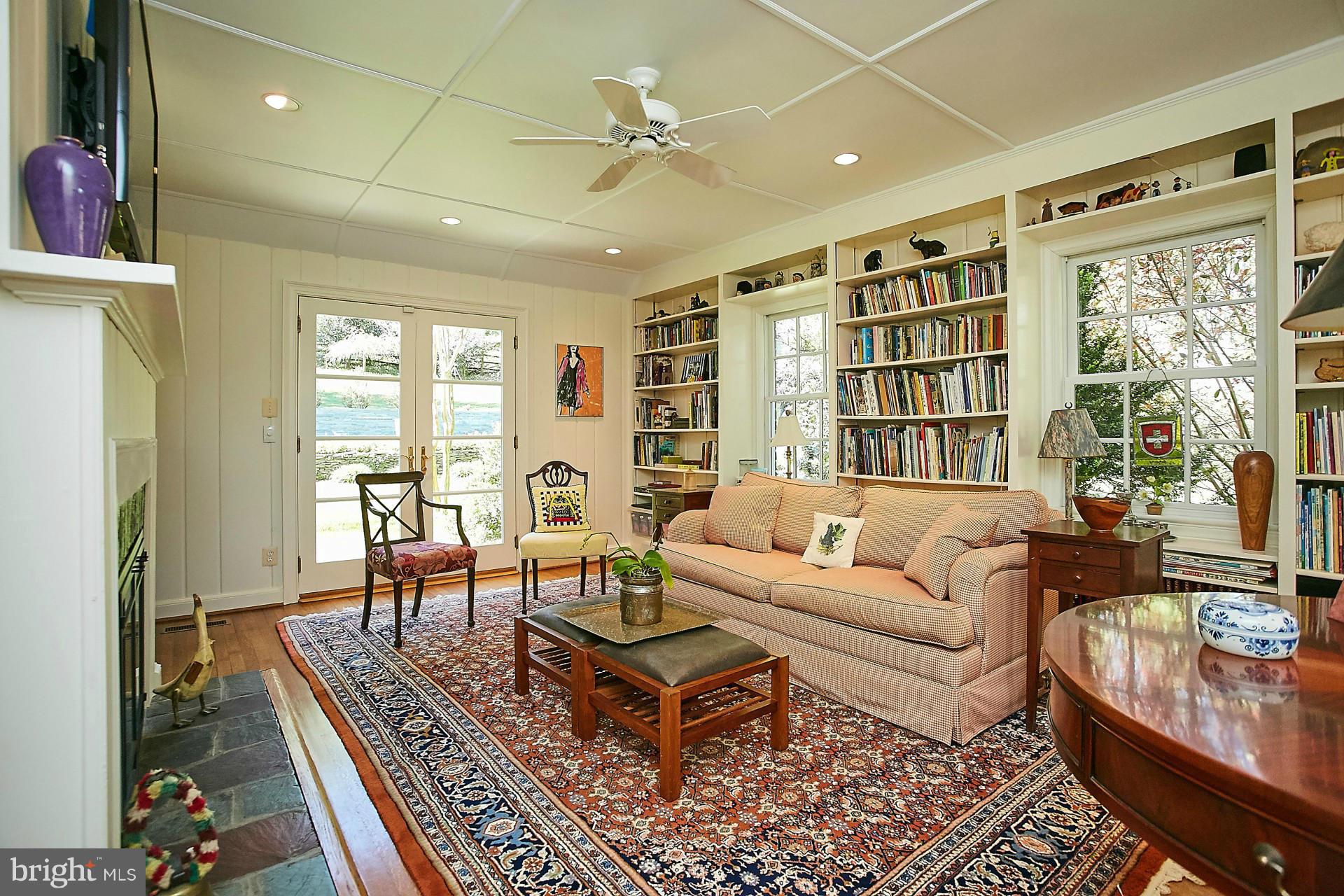 6539 Georgetown Pike McLean, VA 22101 - Photo 9 of 30 a living room with furniture ceiling fan and a rug