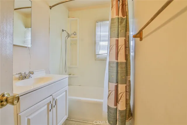a bathroom with a sink vanity tub and a mirror