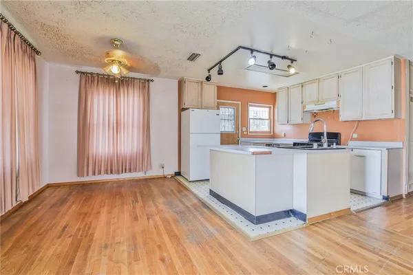 a view of kitchen with cabinets and wooden floor