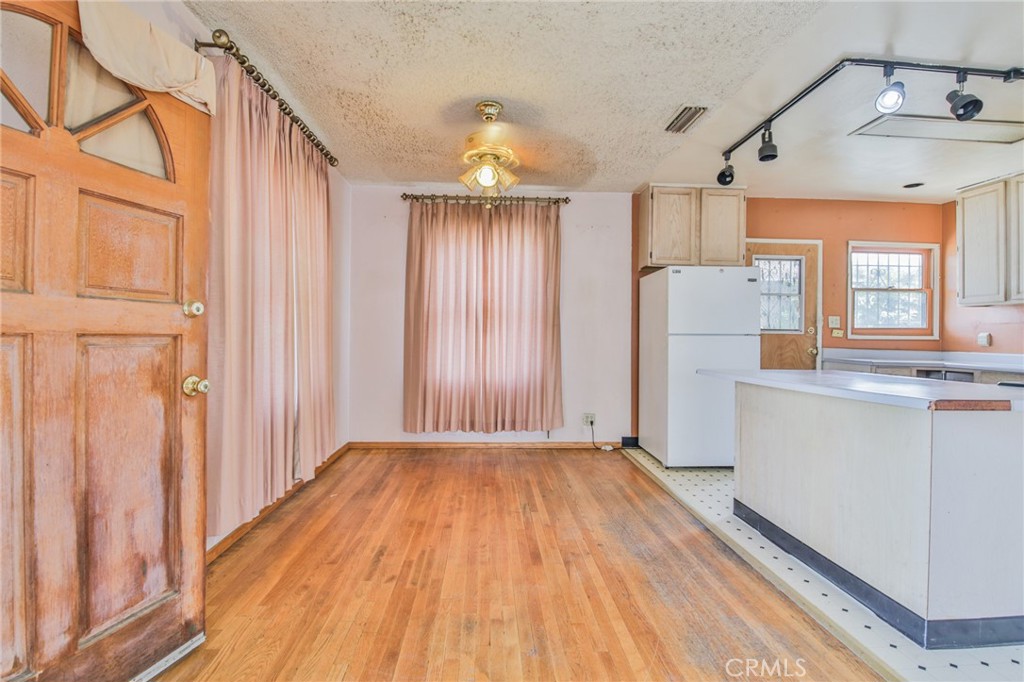 1208 South White Avenue Compton, CA 90221 - Photo 4 of 46 a view of a hallway with wooden floor and door