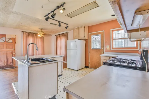 a kitchen with refrigerator and window