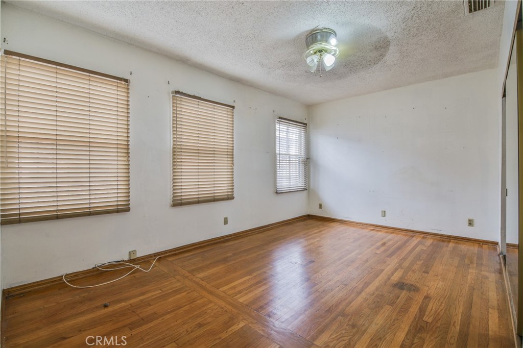 1208 South White Avenue Compton, CA 90221 - Photo 8 of 46 a view of an empty room with wooden floor and a window