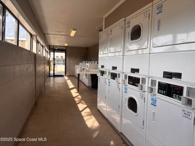 a view of a kitchen with stainless steel appliances wooden floor and a sink