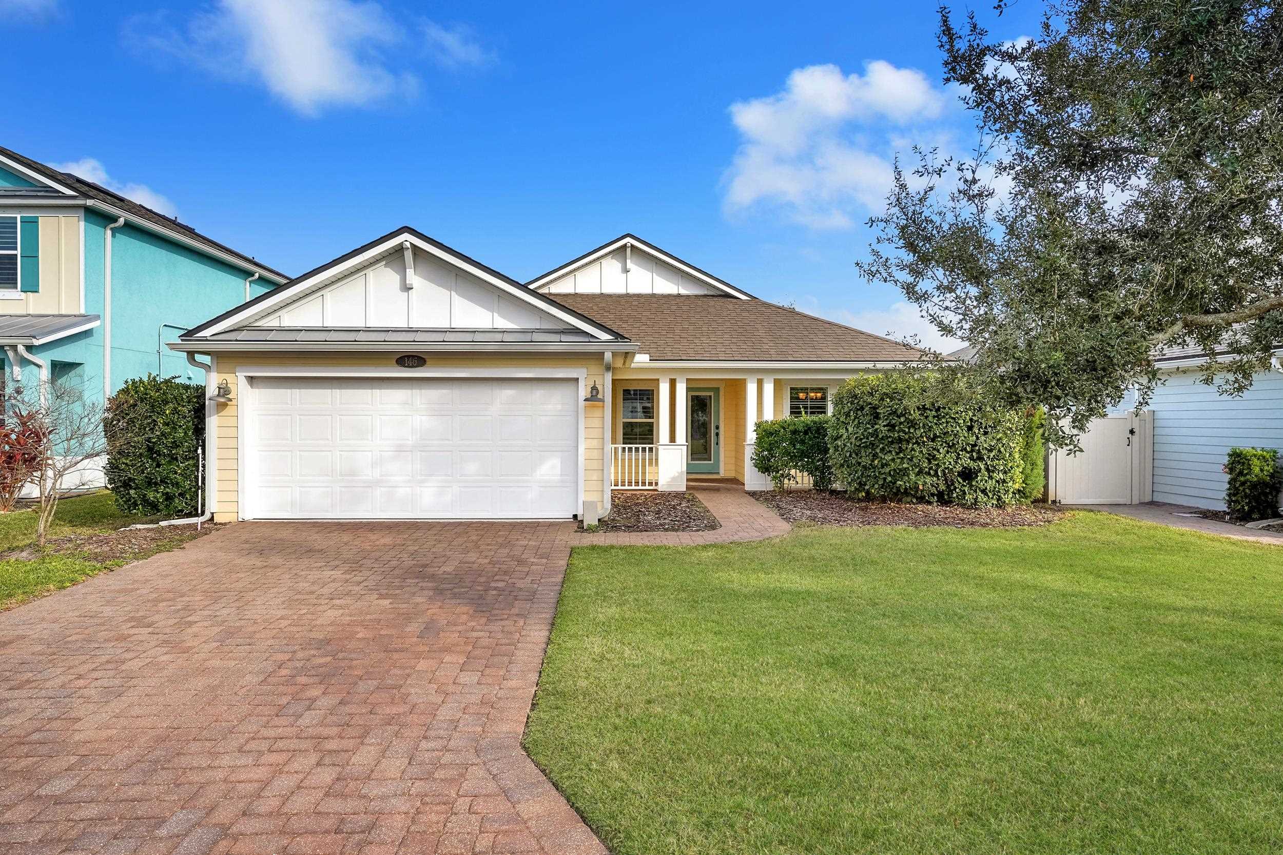 146 Ocean Cay Boulevard St. Augustine, FL 32080 - Photo 1 of 41 a front view of a house with a yard and garage