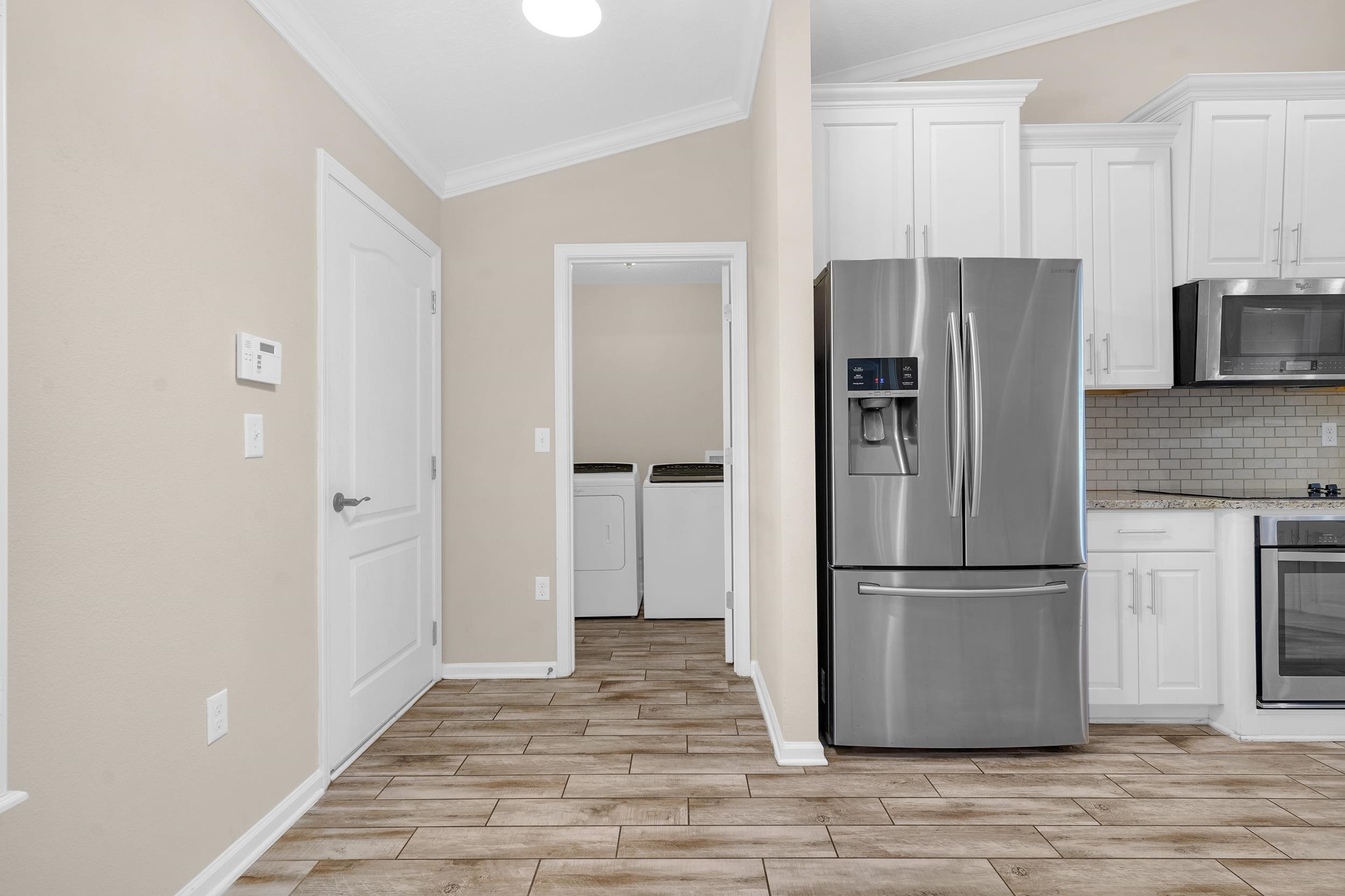146 Ocean Cay Boulevard St. Augustine, FL 32080 - Photo 13 of 41 a kitchen with stainless steel appliances granite countertop a refrigerator and a stove