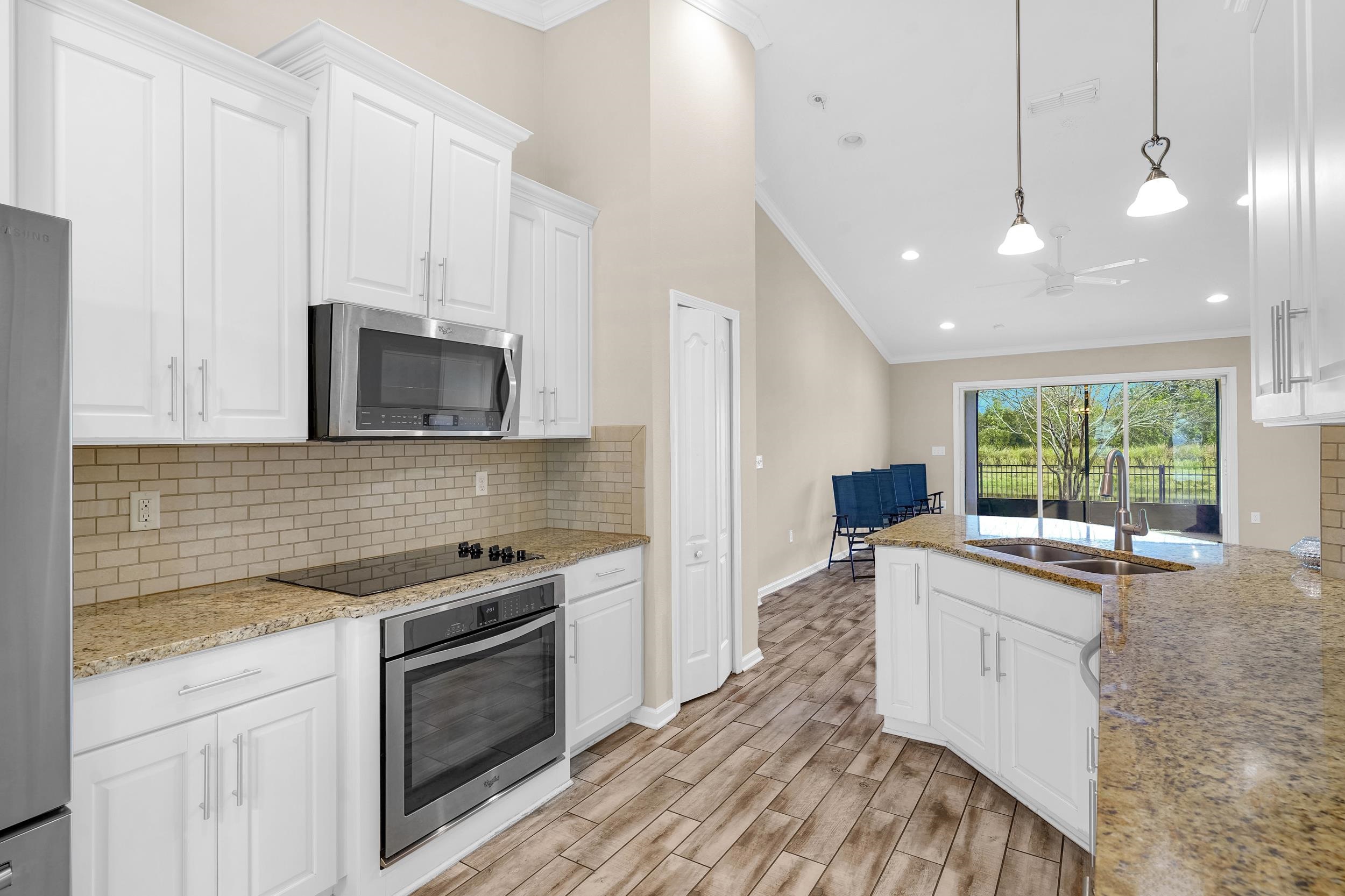 146 Ocean Cay Boulevard St. Augustine, FL 32080 - Photo 14 of 41 a kitchen with a sink stove and microwave