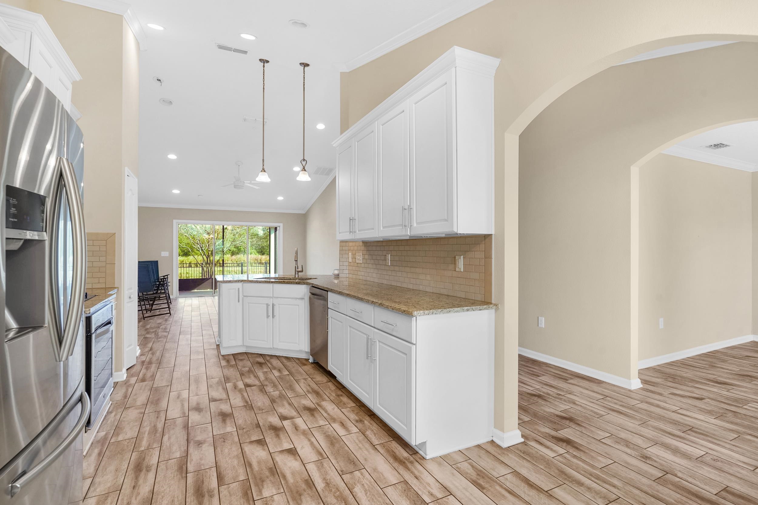 146 Ocean Cay Boulevard St. Augustine, FL 32080 - Photo 16 of 41 a kitchen with a sink a refrigerator and wooden floor