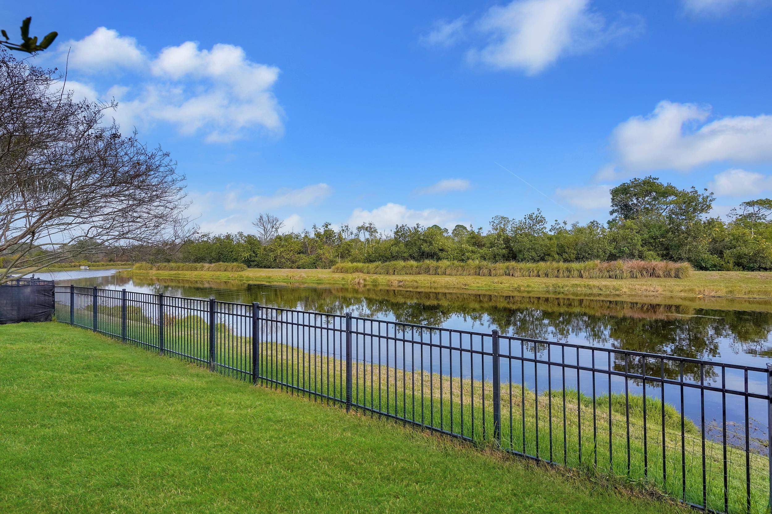 146 Ocean Cay Boulevard St. Augustine, FL 32080 - Photo 2 of 41 a view of a lake with a garden and trees