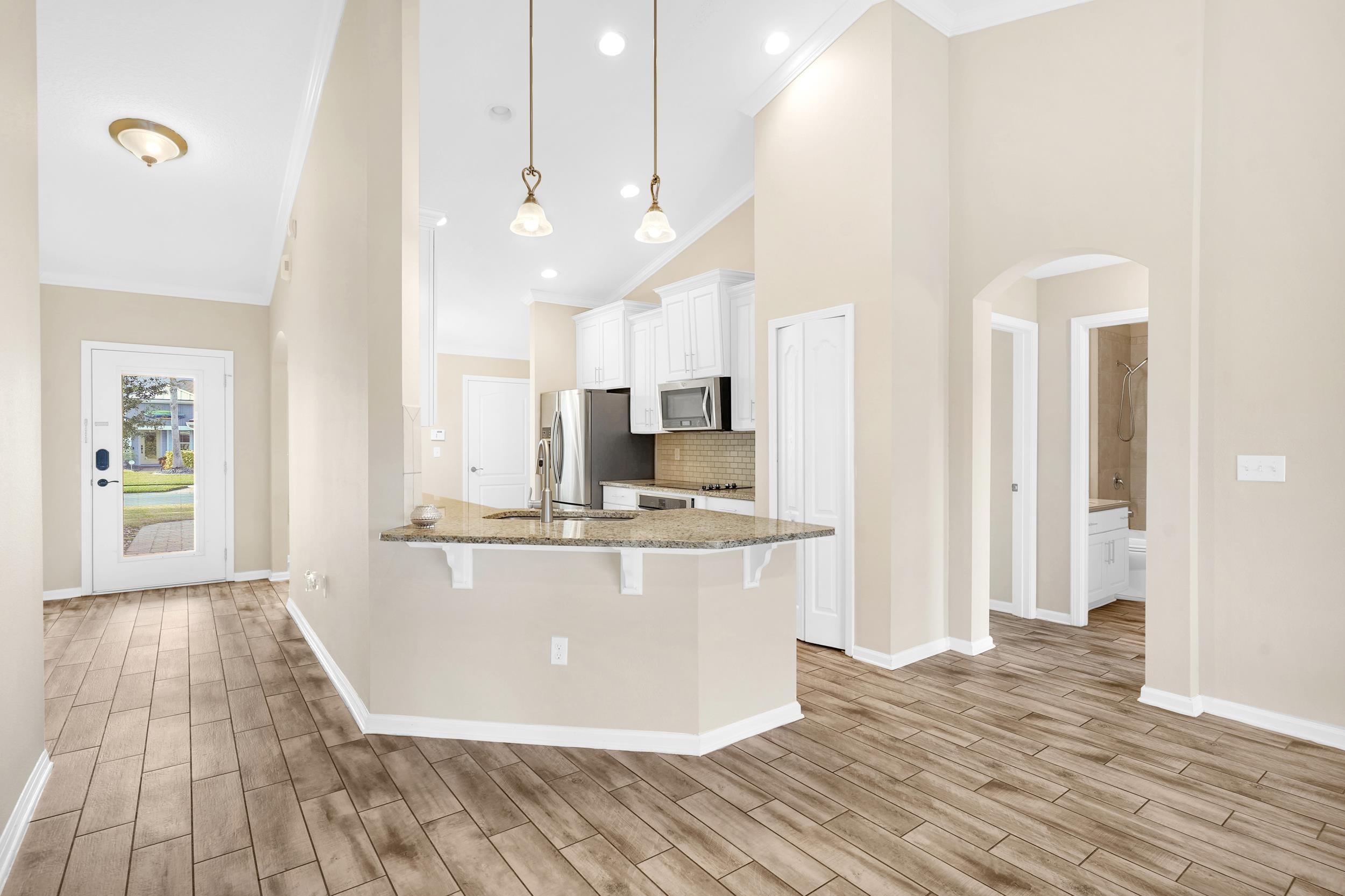 146 Ocean Cay Boulevard St. Augustine, FL 32080 - Photo 21 of 41 a view of kitchen with stainless steel appliances granite countertop a stove and a wooden floors