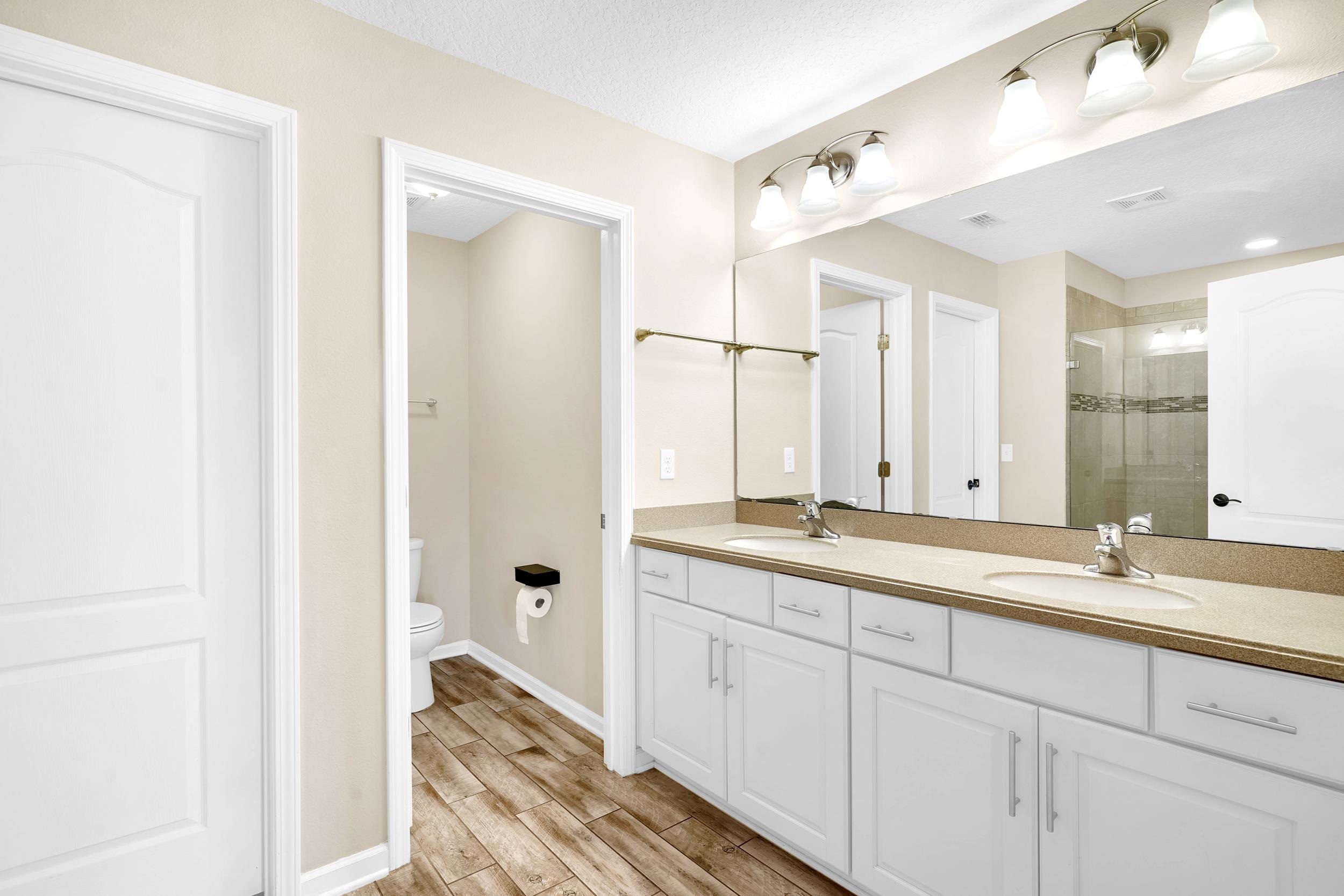 146 Ocean Cay Boulevard St. Augustine, FL 32080 - Photo 25 of 41 a en suite bathroom with a granite countertop sink mirror and double