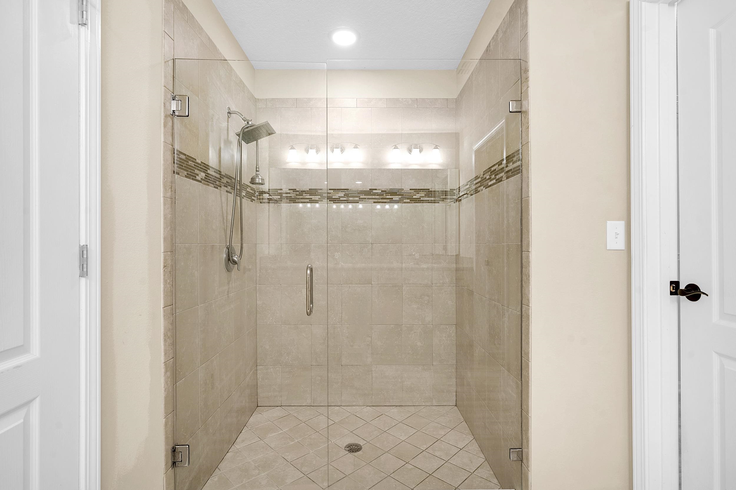 146 Ocean Cay Boulevard St. Augustine, FL 32080 - Photo 26 of 41 a bathroom with a glass shower door